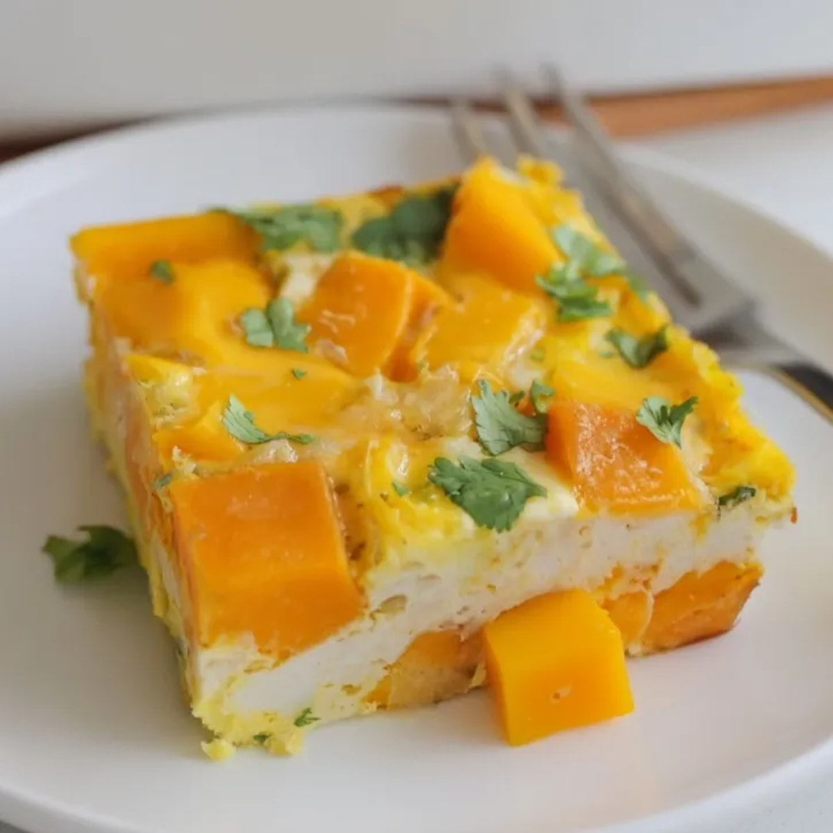 Golden Mango Sweet Potato Egg Bake, a colorful breakfast casserole with sweet tropical flavors.