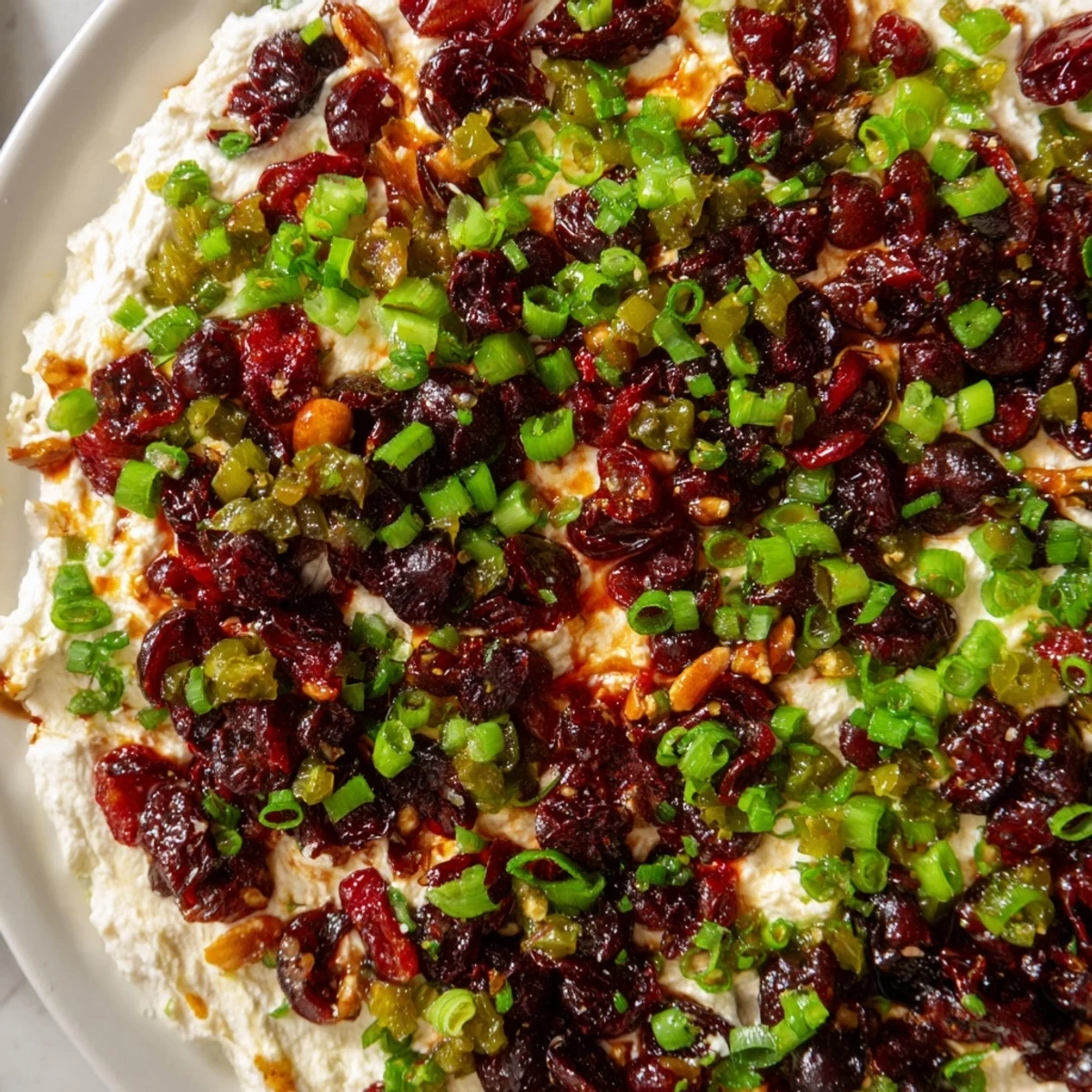 Spicy Ginger Cranberry Jalapeño Dip served with colorful veggie sticks for a festive appetizer.  