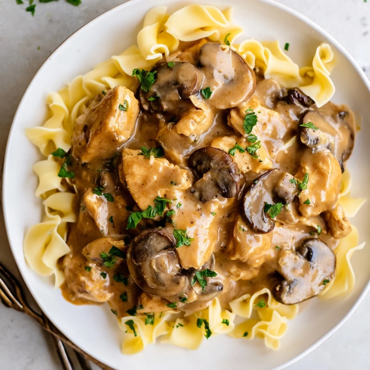 Creamy Chicken Stroganoff served over egg noodles with rich mushroom sauce and fresh parsley.  