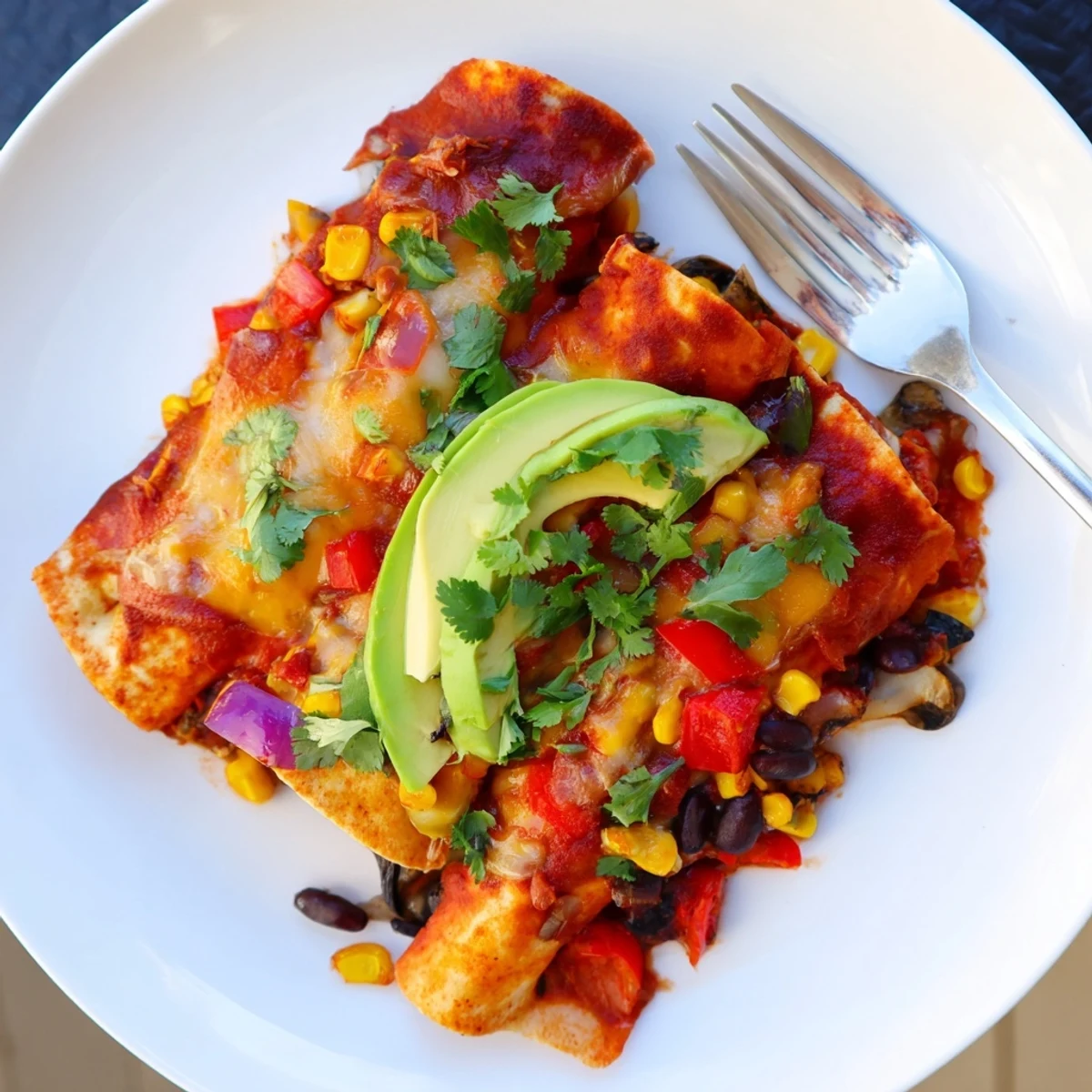 Vibrant Farmers Market Vegetarian Enchiladas topped with melted cheese and fresh cilantro.  
