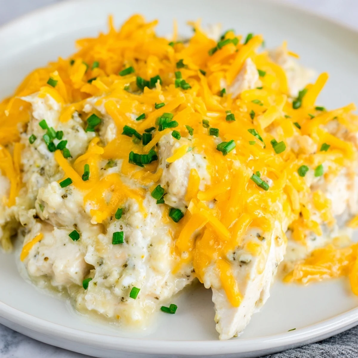 Comforting Cheddar Ranch Chicken Bake topped with golden, bubbly cheese and herbs.