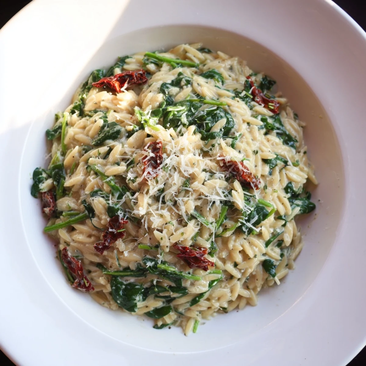 Creamy Tuscan Orzo Bowl with vibrant spinach, sun-dried tomatoes, and a comforting Parmesan sauce.