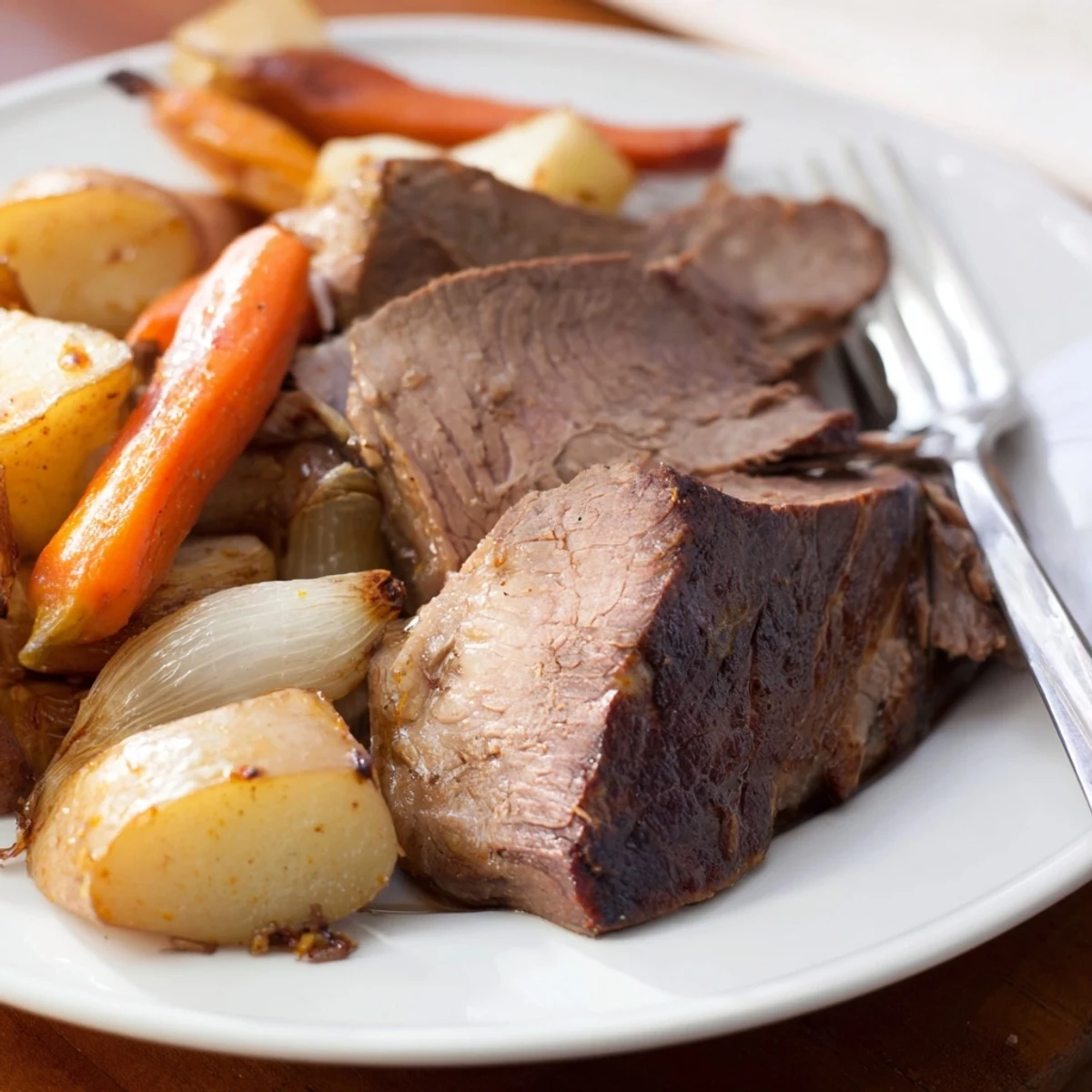 A close-up of a flavorful Sunday Pot Roast, with braised beef and root vegetables.