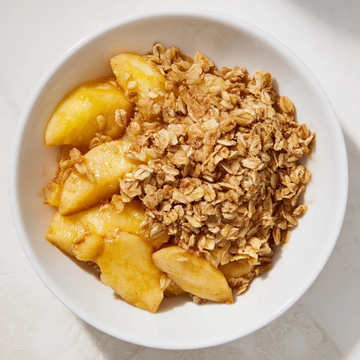 Warm, bubbling apple crisp with a golden, crunchy oat topping made with frozen apples.