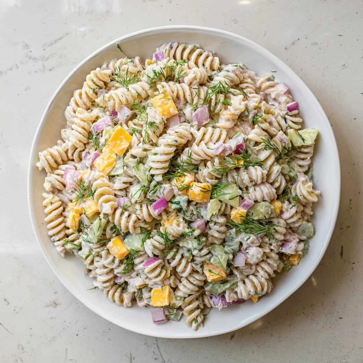 Creamy Dill Pickle Pasta Salad with vibrantly green dill and crunchy pickles, perfect for summer.