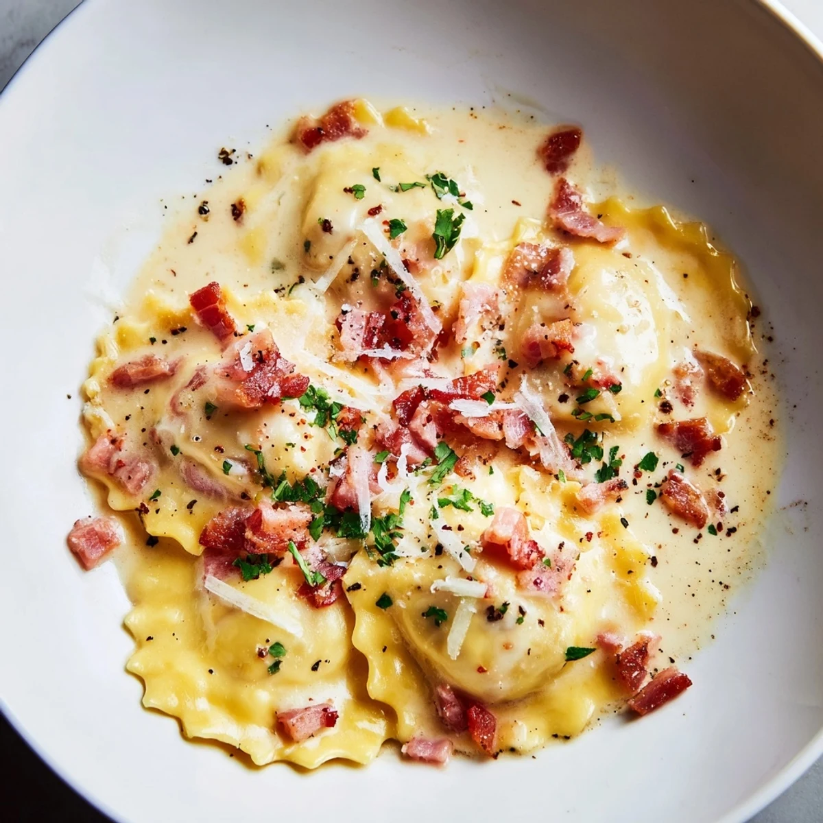 Creamy Olive Garden Ravioli Carbonara, topped with crispy pancetta and fresh parsley, looks absolutely delicious.