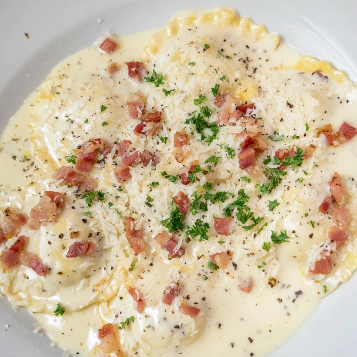 A close-up shot of Olive Garden Ravioli Carbonara showcases rich, cheesy pasta in a luscious sauce.