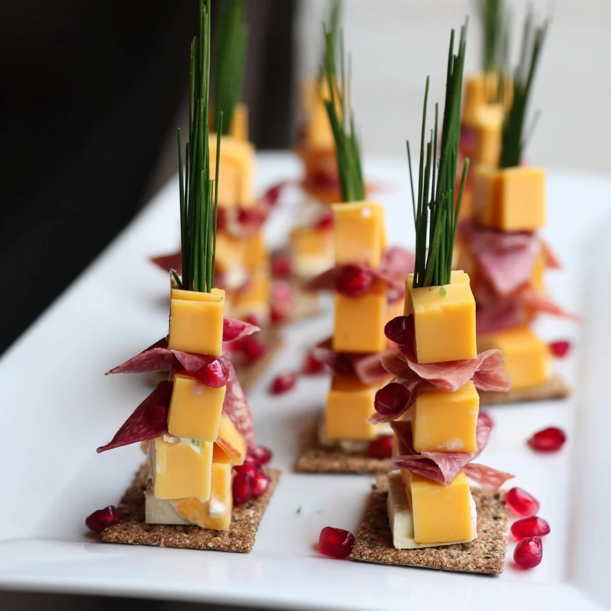Appetizing Layered Urban Skyline appetizer with colorful cheese, meat ribbons, and chive spires ready to serve.