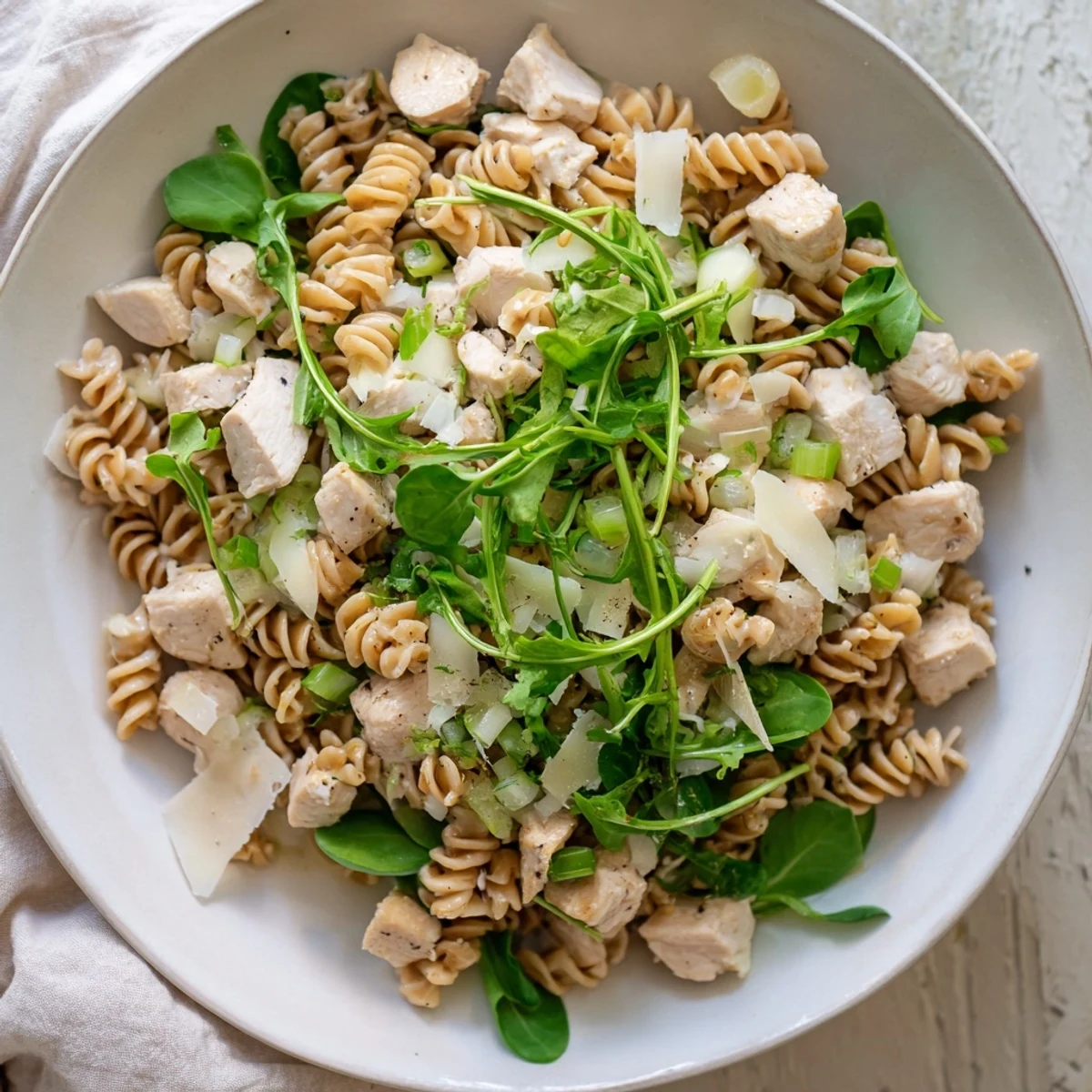 Flavorful One-Pot Spinach and Chicken Pasta with tender chicken and wilted spinach, garnished beautifully.