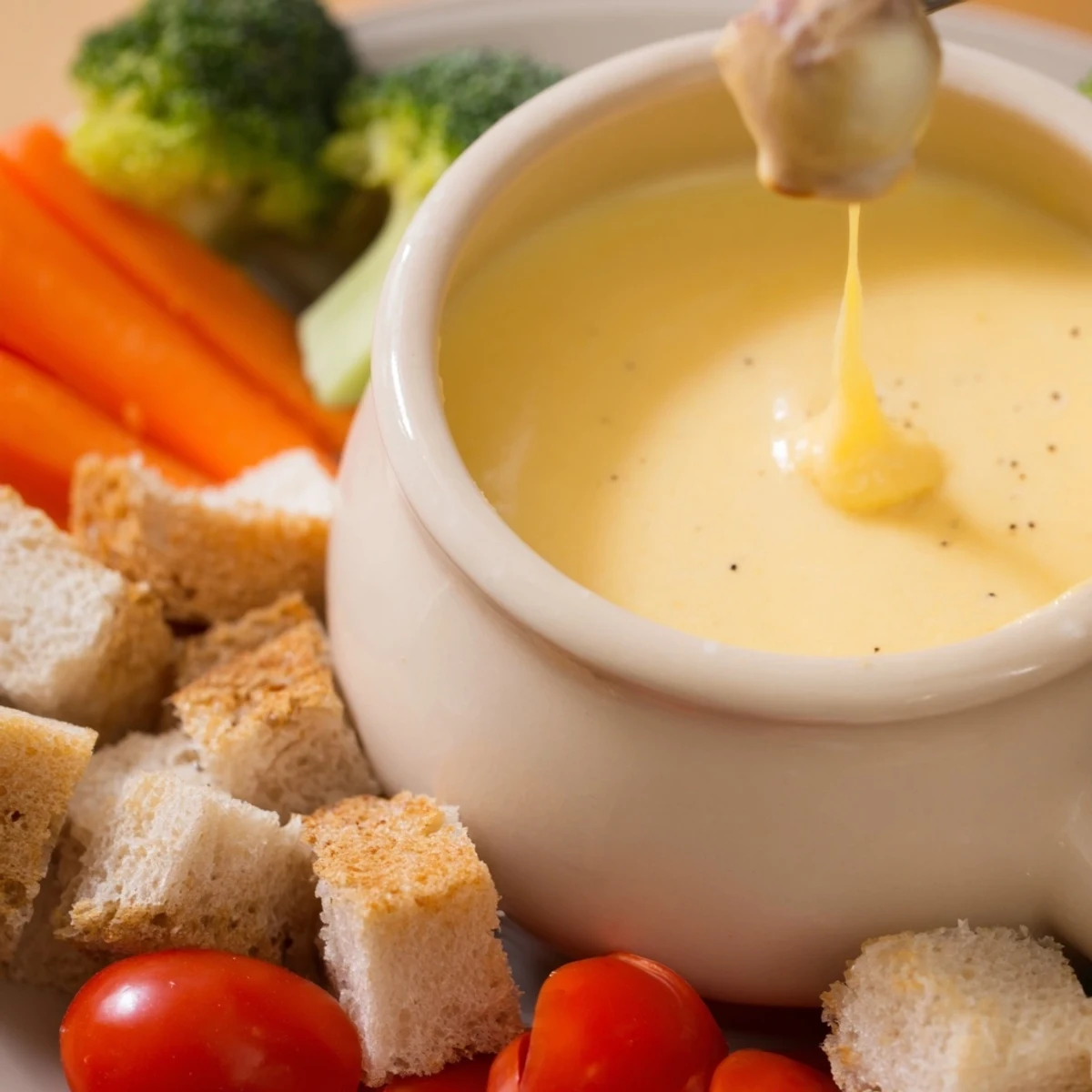 Creamy, bubbling Swiss cheese fondue with chunks of bread ready for dipping; a comforting, shared appetizer.