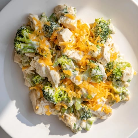 Golden, bubbly Cheddar Broccoli Chicken Bake fresh from the oven, offering cheesy comfort.