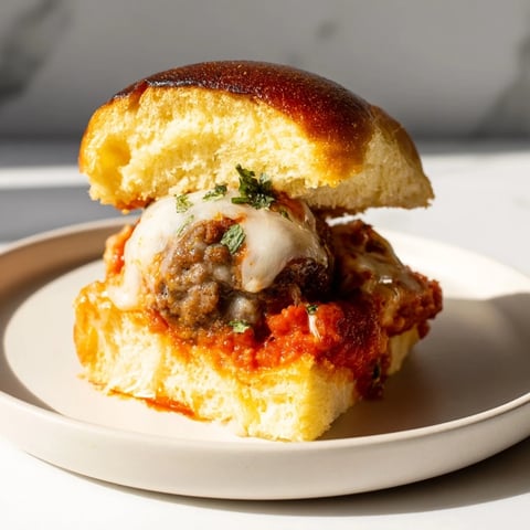 Warm and cheesy Easy Christmas Meatball Sliders ready to serve on a platter, a holiday favorite.