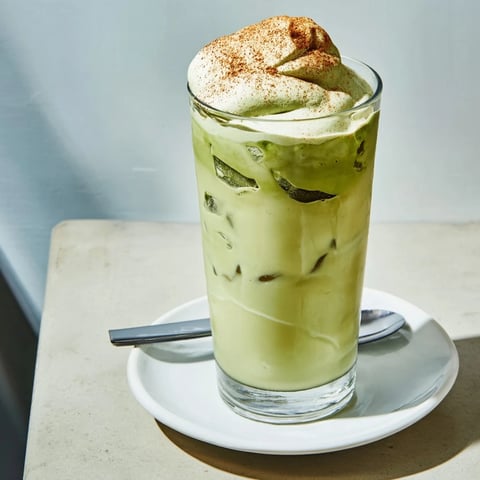 Refreshing Cinnamon Roll Iced Matcha: a layered beverage of green tea, cinnamon, and fluffy protein foam.