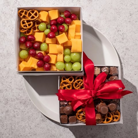 A beautifully arranged Stacked Christmas Gift Snack Tower overflowing with colorful treats perfect for holiday parties.