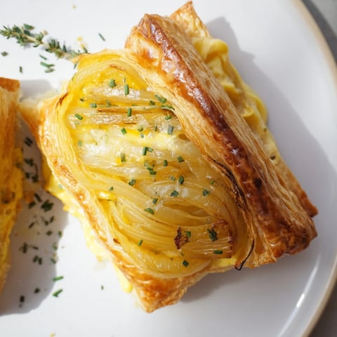 Golden caramelized onions resting on a flaky crust for this savory Caramelized Onion Tart.