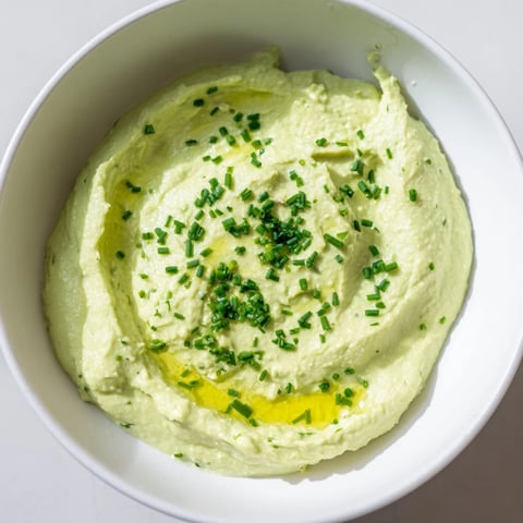 Creamy Avocado Cottage Cheese Dip, a vibrant green dip ready to be scooped with crisp veggies.