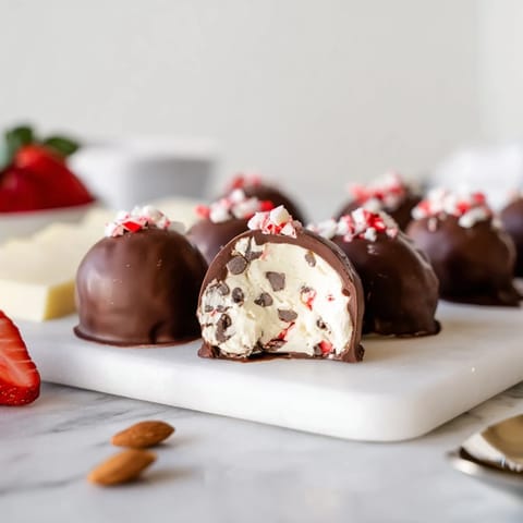 Irresistible peppermint cream cheese filling inside Charcuterie Board Peppermint Bark Balls, perfect for holiday gatherings.  