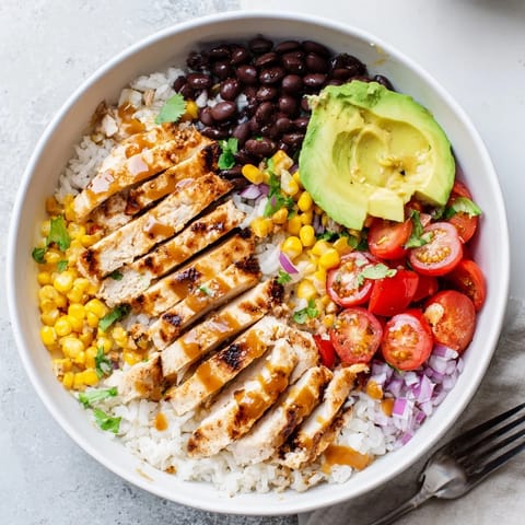 Savory Honey Chipotle Chicken served over colorful rice with black beans and corn.  