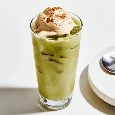 Homemade Cinnamon Roll Iced Matcha latte: cool, invigorating drink with a light cinnamon dusting on top.