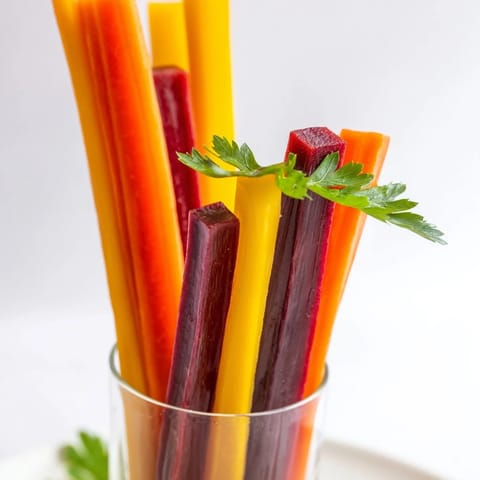 Fresh, crisp Simple Crudités: these rainbow carrot sticks offer a refreshing crunch, ready to enjoy.