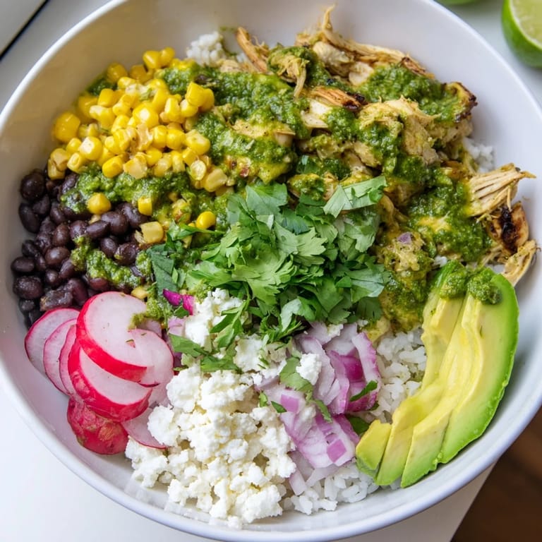 Colorful green enchiladas rice bowl featuring fluffy rice, zesty sauce, and crumbled cheese.