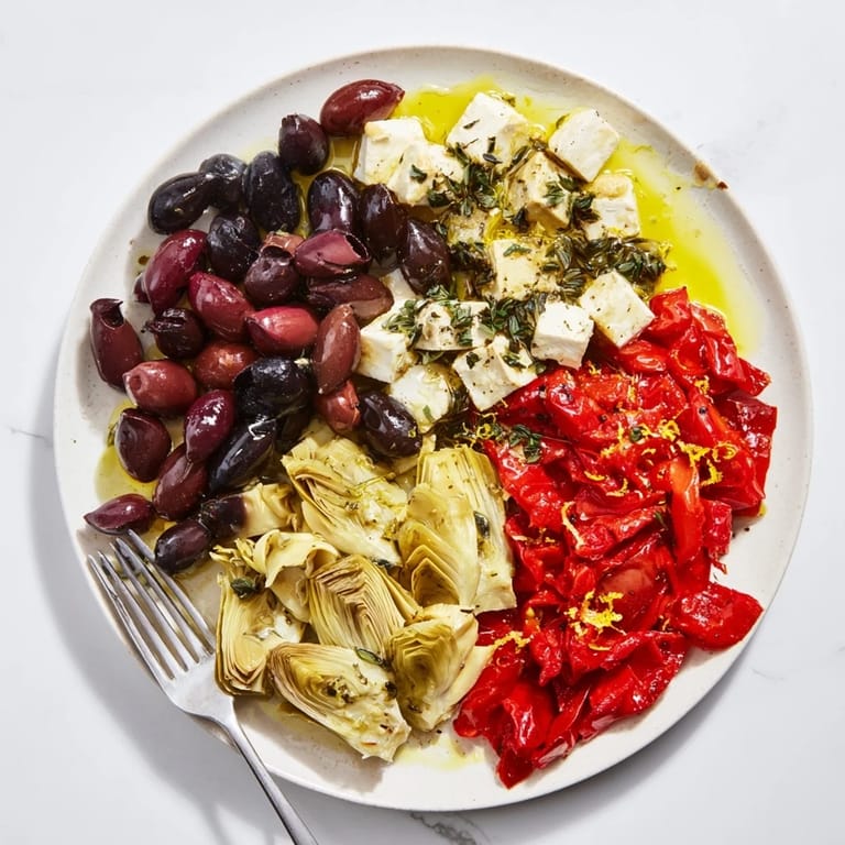 Vibrant red sun-dried tomatoes and black olives star in this appetizer Black Olive and Tomato platter.