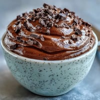 Creamy cottage cheese chocolate mousse with rich cocoa and dark chocolate, topped with fresh raspberries for a protein-packed dessert.